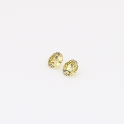 0.10 Total carat pair of round-cut fancy yellow diamonds