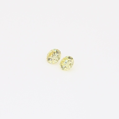 0.09 Total carat pair of round-cut fancy intense yellow diamonds