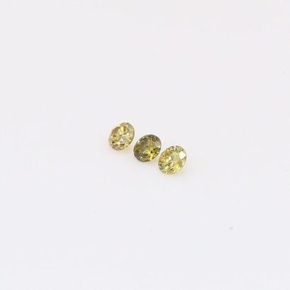 0.06 Total carat pair of round-cut fancy green diamonds