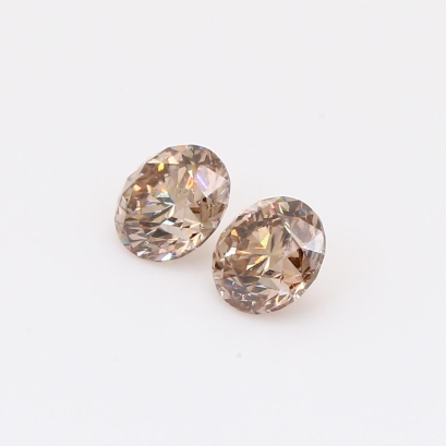 0.91 Total carat pair of brilliant-cut round champagne diamonds