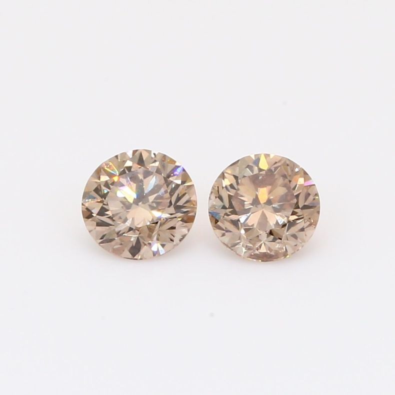 0.91 Total carat pair of brilliant-cut round champagne diamonds