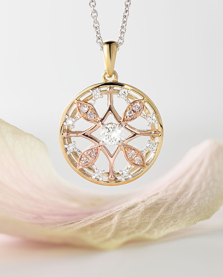 Tessera necklace featuring Argyle pink diamonds and white diamonds suspended above a flower petal