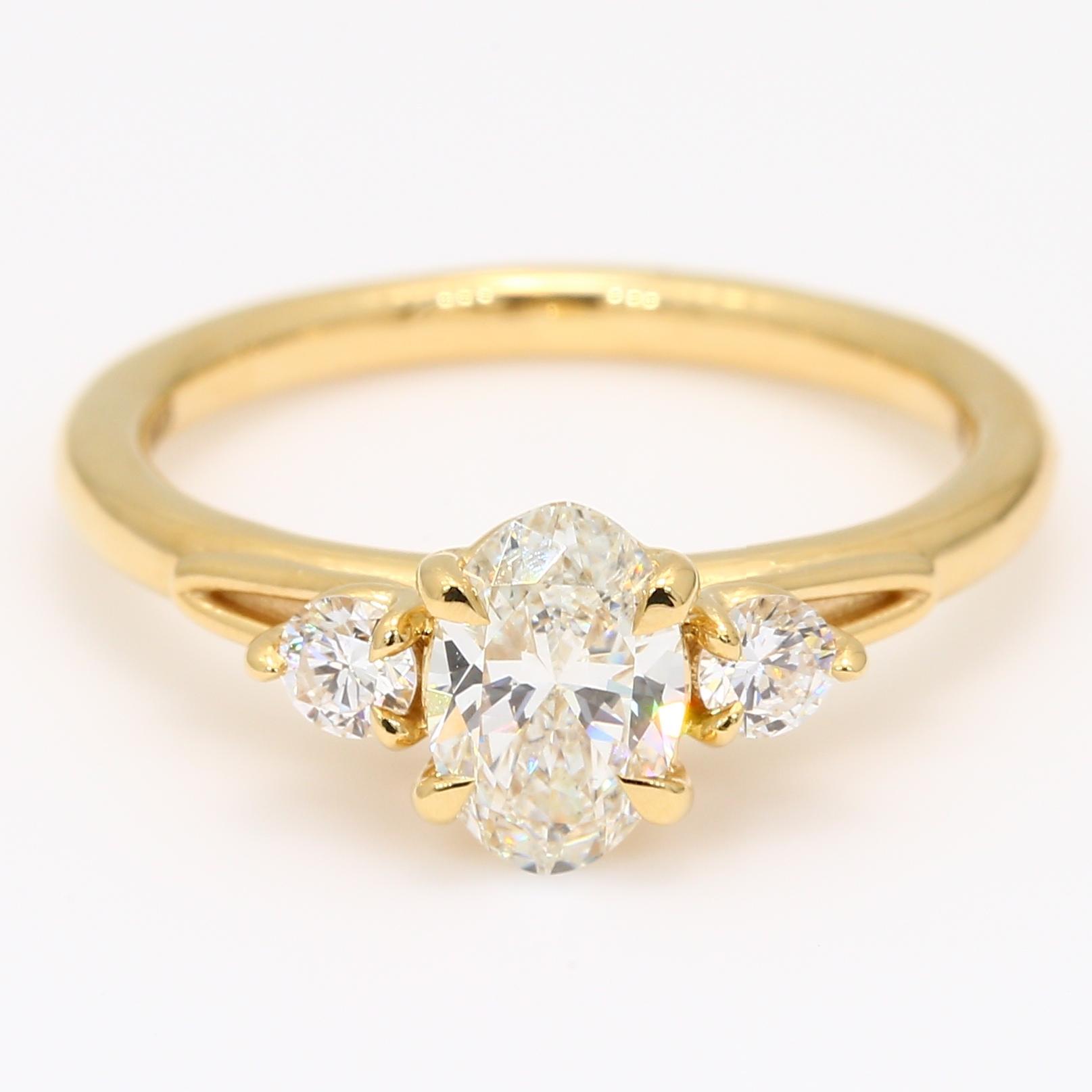 Francine oval and round-cut white diamond three-stone engagement ring