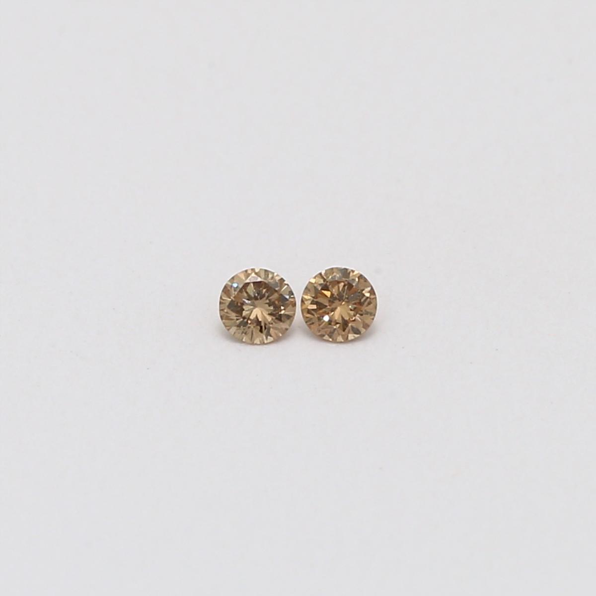 0.10 Total carat pair of champagne diamonds