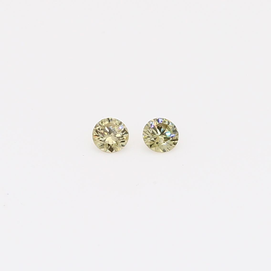 0.08 Total carat weight pair of round-cut fancy green diamonds