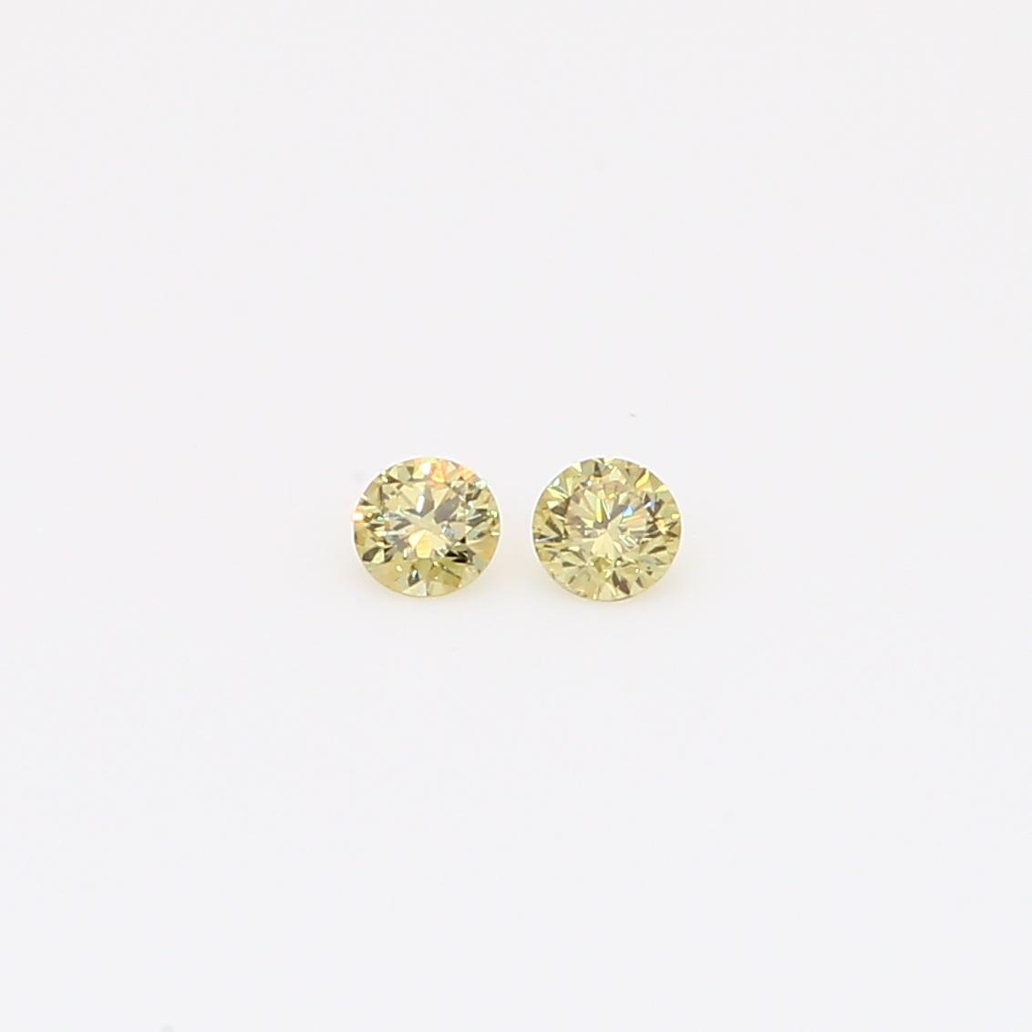 0.10 Total carat pair of round-cut fancy yellow diamonds