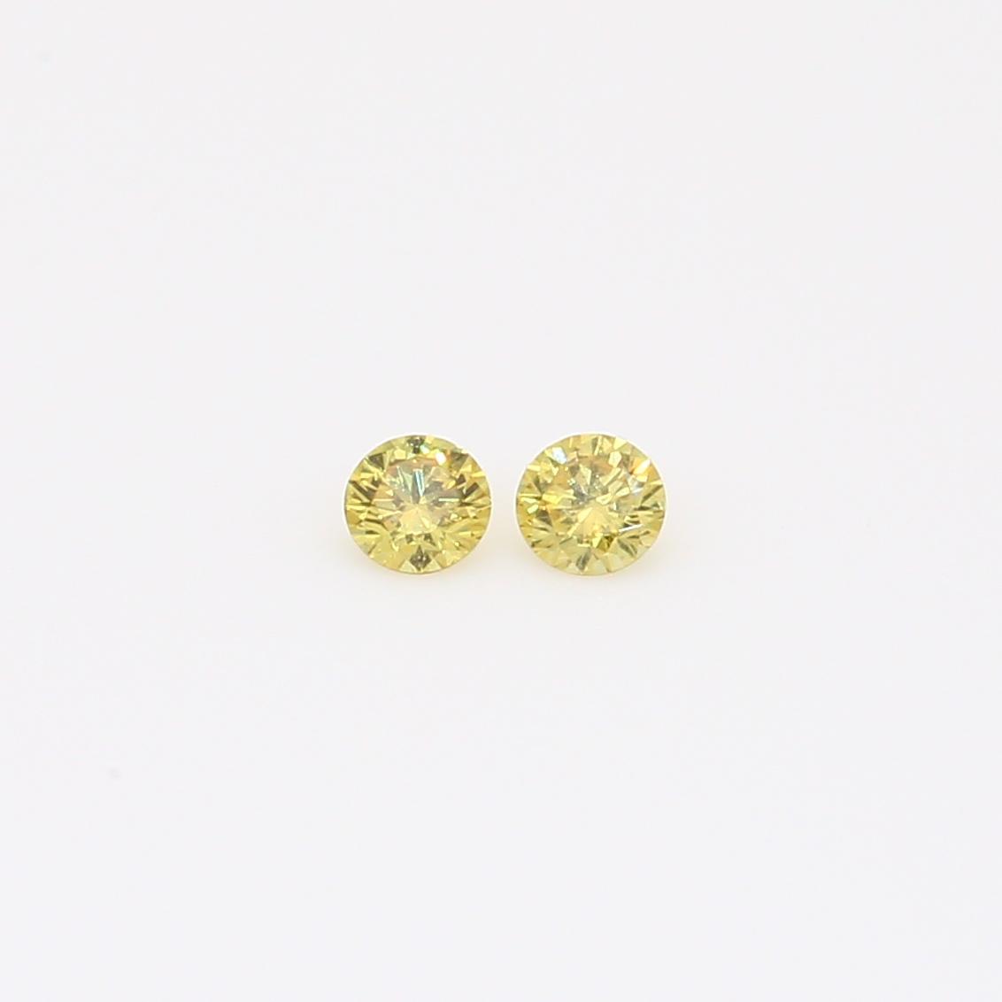 0.10 Total carat pair of round-cut fancy green diamonds