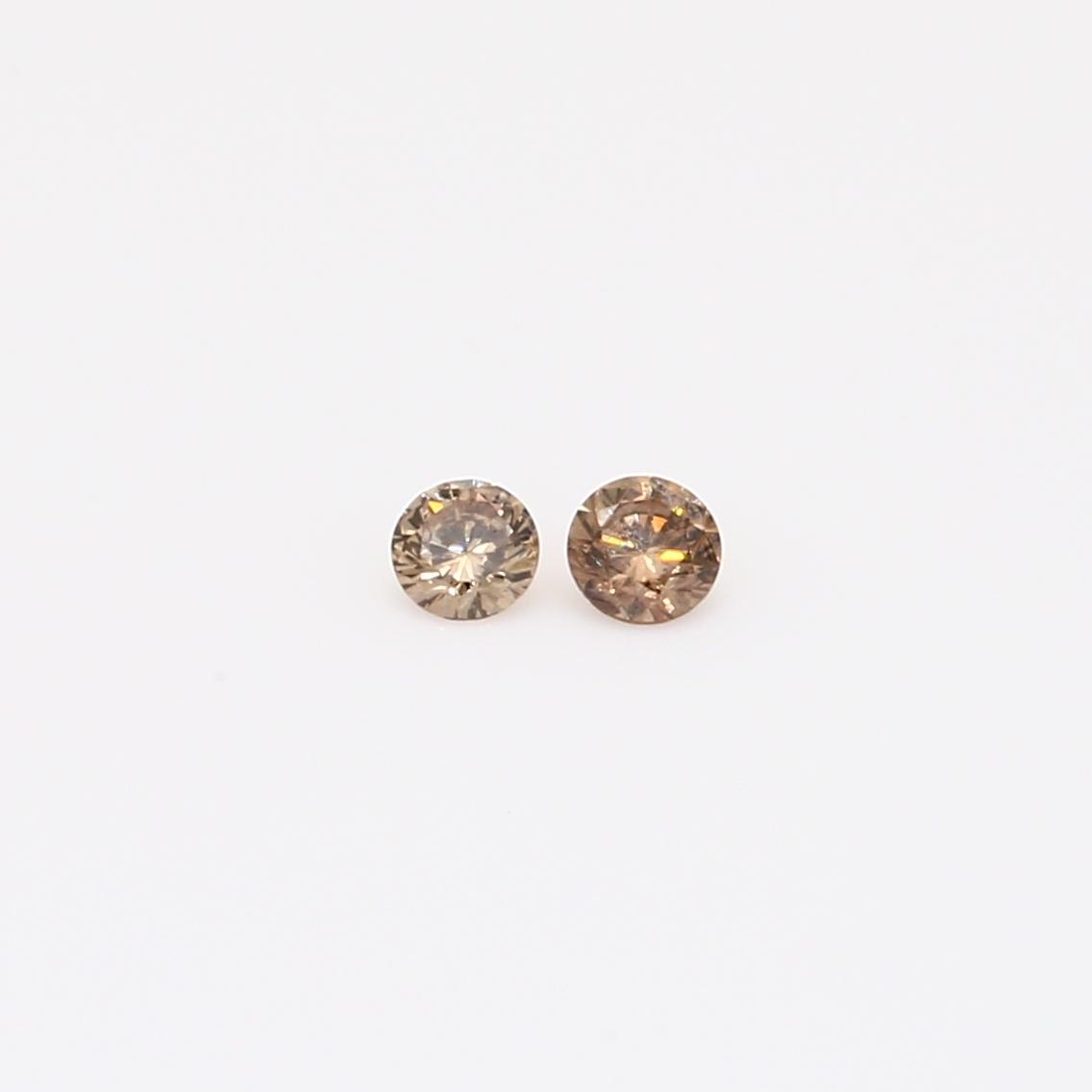 0.10 Total carat pair of round-cut champagne diamonds