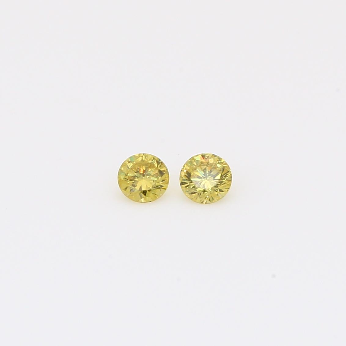 0.12 Total carat pair of round-cut fancy green diamonds