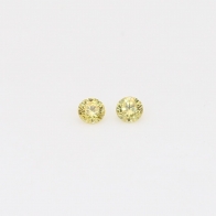 0.06 Total carat pair of round cut yellow diamonds