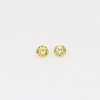0.06 Total carat pair of round cut yellow diamonds