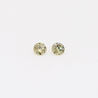 0.08 Total carat weight pair of round-cut fancy green diamonds
