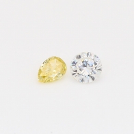 0.49 Total carat pair of pear cut fancy yellow and round cut white diamonds