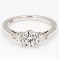 Fuji pear and round cut white diamond three stone engagment ring