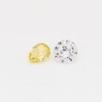 0.49 Total carat pair of pear cut fancy yellow and round cut white diamonds