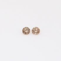 0.08 Total carat pair of round-cut champagne diamonds