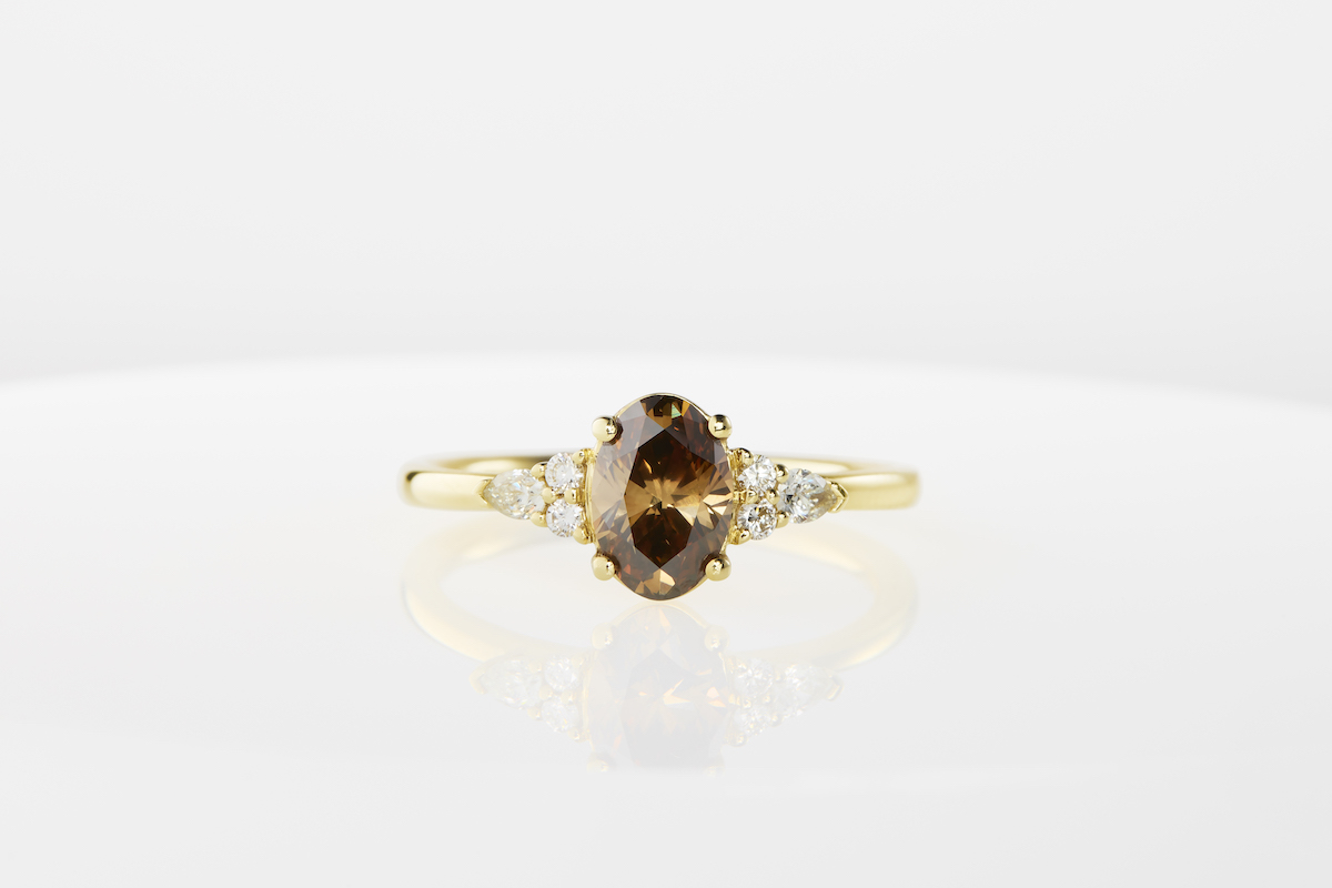 gold engagement ring with a champagne diamond and smaller white diamonds