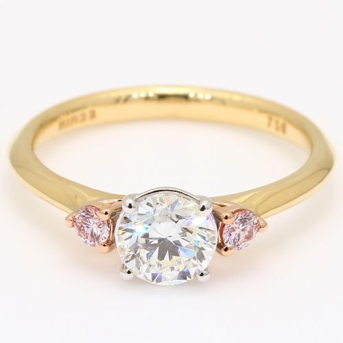 diamond engagement ring with three stones and pink diamonds